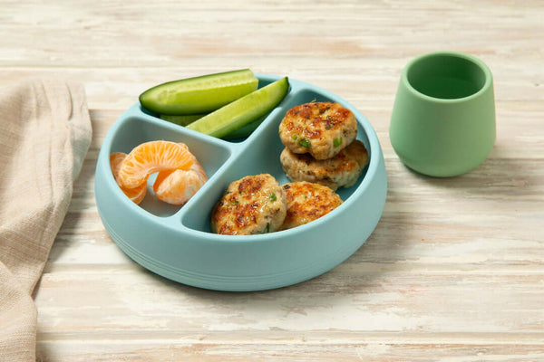 Tiny Turtle Pesto Chicken Patties on a blue plate with fruit and vegetables