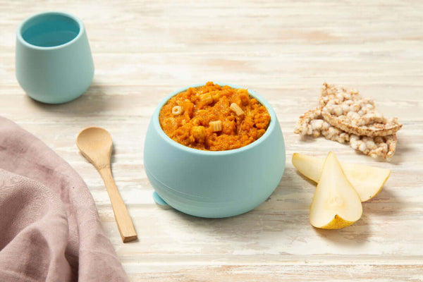 Baby bowl containing stage 3 beef bolognaise with spelt pasta with baby cup and pear