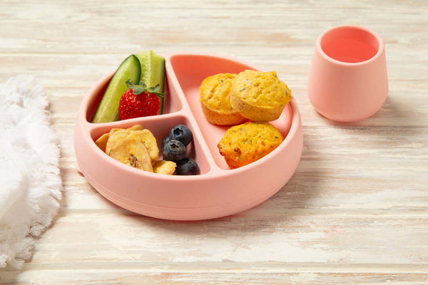 Toddler food egg bites on a pink plate with cucumber and banana