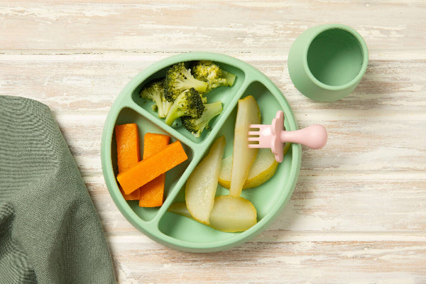 First Finger Food Pack with steamed pumpkin batons, broccoli florets, and pear pieces on a green plate.