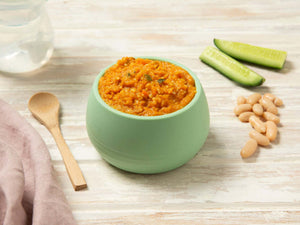 Moroccan lamb and cous cous baby puree in a green bowl
