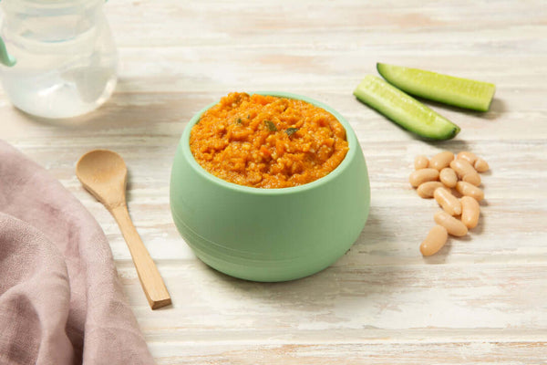 Moroccan lamb and cous cous baby puree in a green bowl