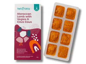 Tiny Turtle food packaging with a tray of pre-portioned meals on a white background