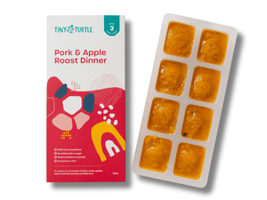Pork and Apple Roast Dinner Stage 3 baby food by Tiny Turtle, featuring lumpy textured puree in tray next to packaging.
