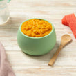 Load image into Gallery viewer, Bowl of stage 3 summer mango chicken with brown rice baby food with lumpy puree with watermelon pieces on a wooden surface.