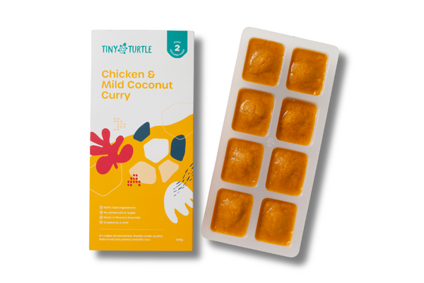 Tiny Turtle baby food packaging with chicken and mild coconut curry on a white background