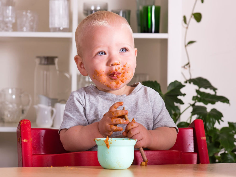 Cute baby enjoying Tiny Turtle Greek chicken and tomato risoni 