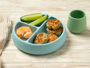 Tiny Turtle Pesto Chicken Patties on a blue plate with fruit and vegetables
