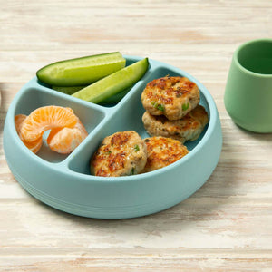 Tiny Turtle Pesto Chicken Patties on a blue plate with fruit and vegetables