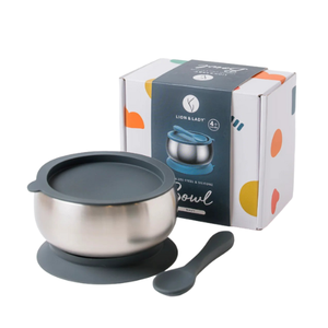 Stainless steel bowl with lid and spoon on a white background, featuring Lion & Lady packaging.