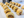Row of sausage rolls on a tray in a kitchen setting