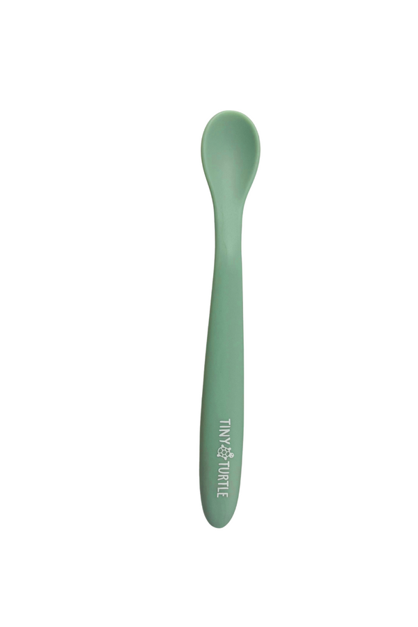 Green spoon with 'Tiny Turtle' branding on a white background