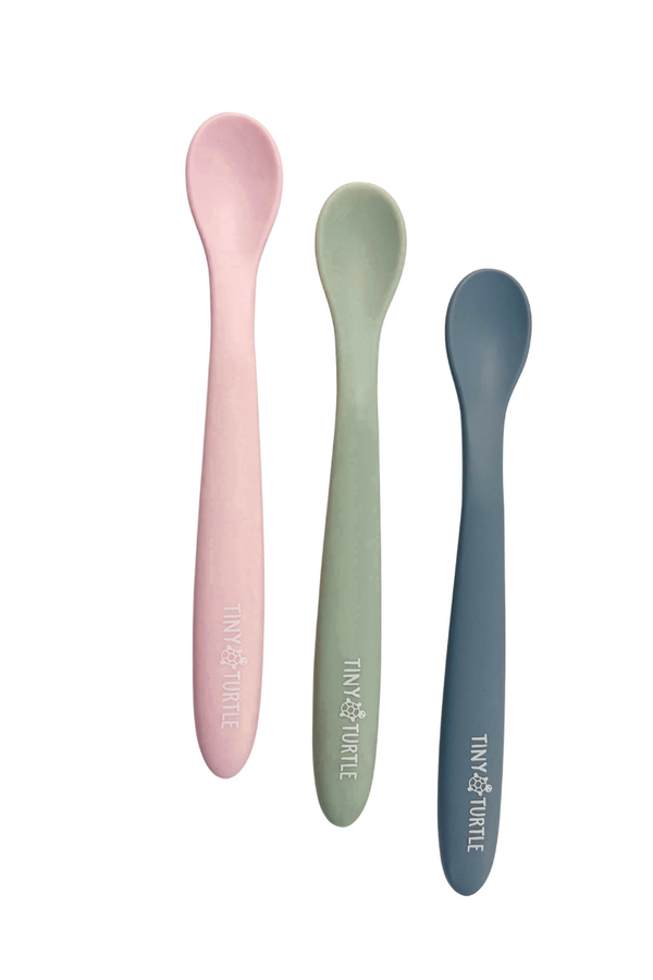 Three colorful spoons with 'Tiny Turtle' branding on a white background