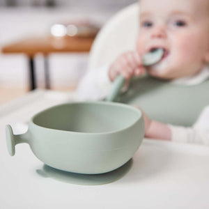 Bbox silicone suction bowl in soft green, designed for toddlers, featuring a strong base and easy grip handle for independent eating.