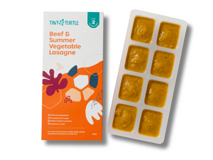 Beef and summer vegetable lasagne Stage 2 baby food by Tiny Turtle, featuring textured puree in tray next to packaging.