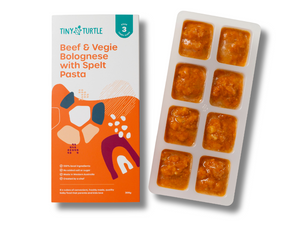 Tiny Turtle baby food packaging with a tray of baby food cubes on a white background