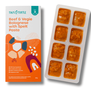 Tiny Turtle baby food packaging with a tray of baby food cubes on a white background