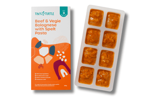 Tiny Turtle baby food packaging with a tray of baby food cubes on a white background