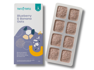 Packaging of Tiny Turtle baby food with a tray of food cubes on a white background