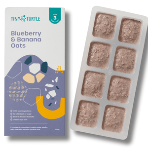 Packaging of Tiny Turtle baby food with a tray of food cubes on a white background