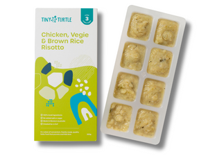Tiny Turtle baby food packaging with chicken, veggie, and brown rice risotto on a white background
