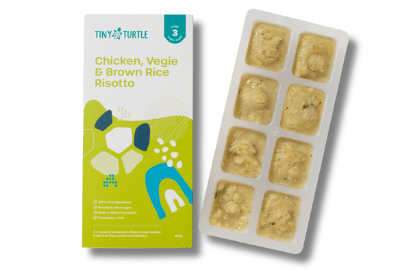 Tiny Turtle baby food packaging with chicken, veggie, and brown rice risotto on a white background