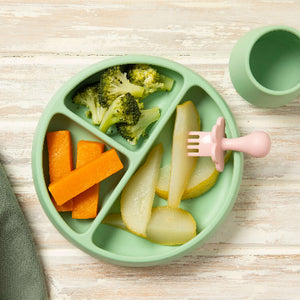 First Finger Food Pack with steamed pumpkin batons, broccoli florets, and pear pieces on a green plate.