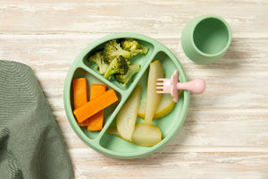 First Finger Food Pack with steamed pumpkin batons, broccoli florets, and pear pieces on a green plate.