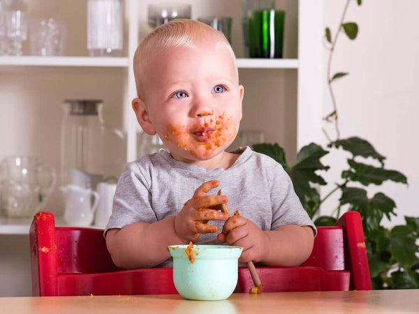 Cute baby enjoying Tiny Turtle Greek chicken and tomato risoni 