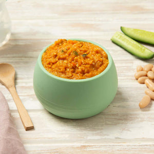 Moroccan lamb and cous cous baby puree in a green bowl 