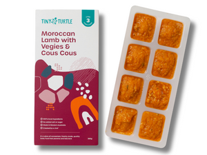 Tiny Turtle food packaging with a tray of pre-portioned meals on a white background