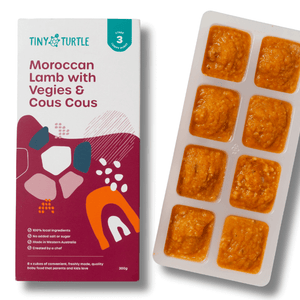 Tiny Turtle food packaging with a tray of pre-portioned meals on a white background