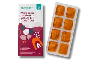Tiny Turtle food packaging with a tray of pre-portioned meals on a white background