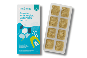Salmon with vegies coconut and herbs Stage 3 baby food by Tiny Turtle, featuring lumpy textured puree in tray next to packaging.