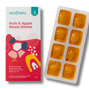 Pork and Apple Roast Dinner Stage 3 baby food by Tiny Turtle, featuring lumpy textured puree in tray next to packaging.
