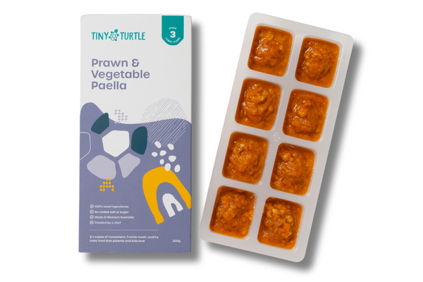 Prawn & Vegetable Paella packaging and tray with food on a white background