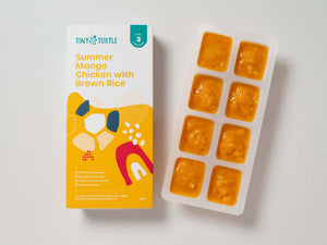 Summer Mango Chicken Stage 3 baby food by Tiny Turtle, featuring lumpy puree in tray next to packaging.