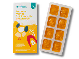 Tiny Turtle baby food packaging with a tray of yellow baby food cubes on a white background