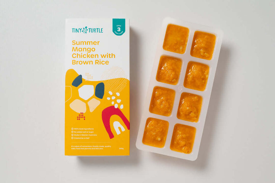 Summer Mango Chicken Stage 3 baby food by Tiny Turtle, featuring lumpy puree in tray next to packaging.