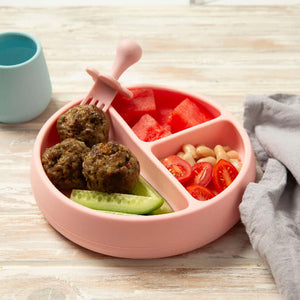 Baby beef meatballs on a pink plate with cucumber and tomato 