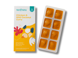 Tiny Turtle baby food packaging with chicken and mild coconut curry on a white background