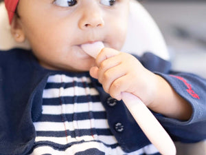 Tiny Turtle Silicone Spoon in use by a baby, showcasing its soft tip and gentle design for mealtime ease.