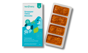 Tiny Turtle baby food packaging with frozen food in a tray on a white background