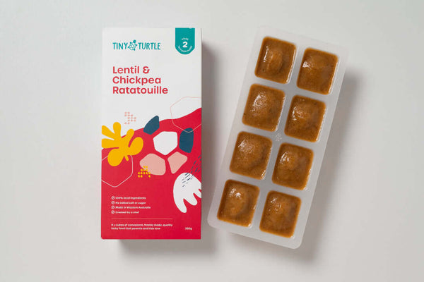 Stage 2 Lentil and Chickpea Ratatouille baby food by Tiny Turtle, featuring 8 frozen puree cubes in tray next to product packaging.